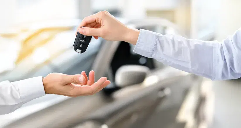 Car keys being handed over to a new owner